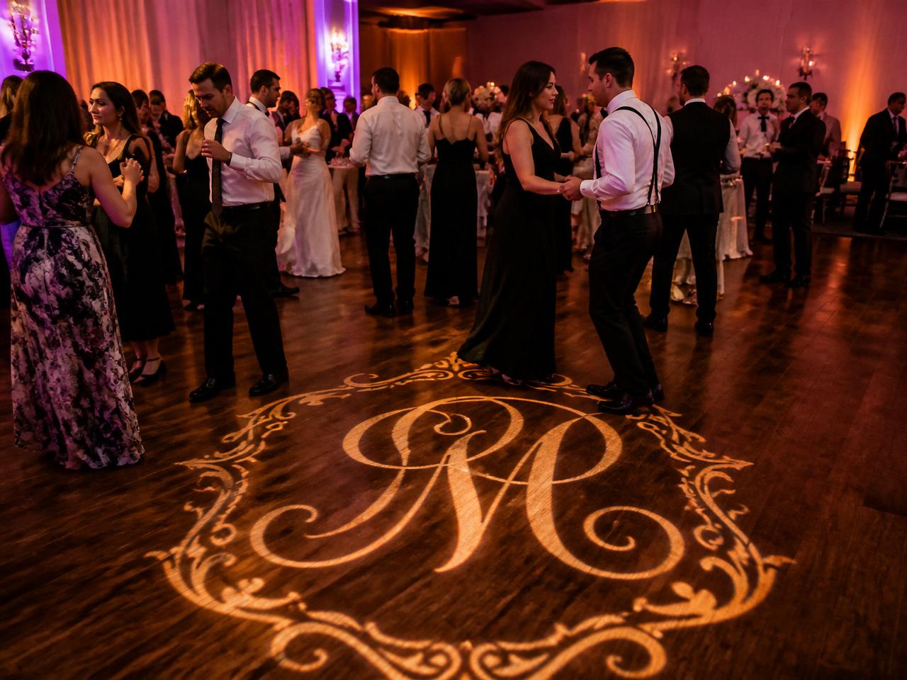 Custom monogram light projected on dance floor
